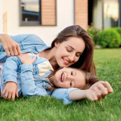 mother and daughter playing outside